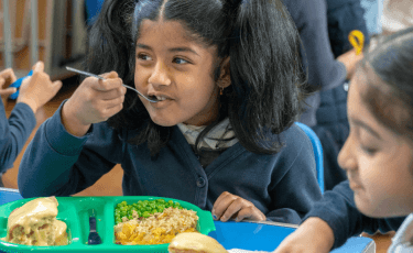 Child eating a school lunch